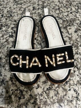 CHANEL Black Slide Mules with Gold Chain Logo